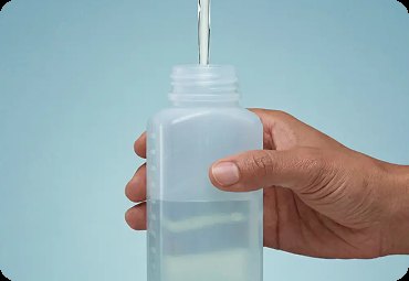 Filling a sample bottle at a kitchen tap